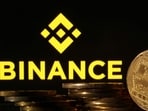 Representations of cryptocurrencies are seen in front of displayed Binance logo in this illustration taken November 10.(REUTERS)