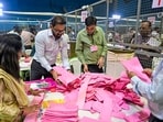 Polling officials handle ballot papers during the counting of votes for the Maharashtra Legislative Council (MLC) election, in Nagpur, Maharashtra.