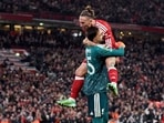 Liverpool's Giorgi Mamardashvili and Kostas Tsimikas celebrate winning the penalty shootout.