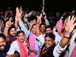 Samajwadi Party workers and supporters celebrate in Lucknow on Wednesday. (HT PHOTO)