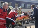 Emergency employees carry a person injured at a railway station during a Russian drone strike, amid Russia's attack on Ukraine, in Dnipro, Ukraine October 29, 2026. 