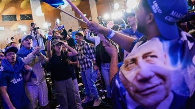 Supporters of Israeli Prime Minister Benjamin Netanyahu celebrate at Likud party headquarters in Jerusalem following the release of the first exit poll results in Israel's general election Wednesday, Oct. 28, 2026.