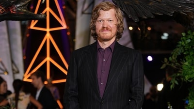 Jesse Plemons plays a young Plutarch Heavensbee in The Hunger Games: Sunrise on the Reaping. For the UK fan screening, he wore a pinstriped black suit with a purple button-down shirt.&nbsp; (AP Photo/Scott A Garfitt)