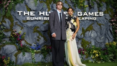 Joseph Zada, who plays Haymitch Abernathy, and Whitney Peak, who plays Lenore Dove Baird, pose during the photocall for the film's UK fan screening.&nbsp; (AP Photo/Scott A Garfitt)