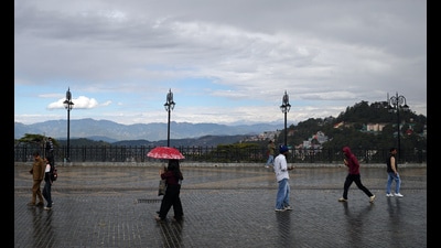 Pedestrians walk holding umbrellas amid light rain, in Shimla on Thursday. (ANI) Pedestrians walk holding umbrellas amid light rain, in Shimla on Thursday. (ANI)