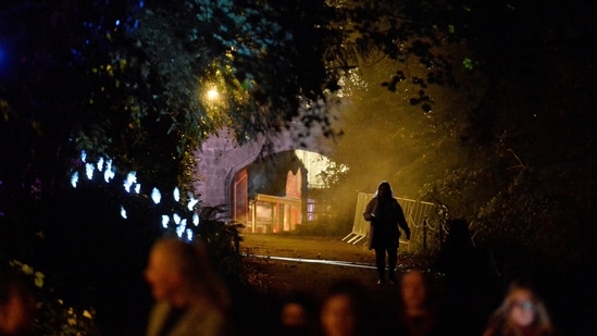 A woman walks on the grounds of Slane Castle during a Halloween festival called 'Puca' celebrating the Celtic tradition of Samhain in Slane, Ireland.