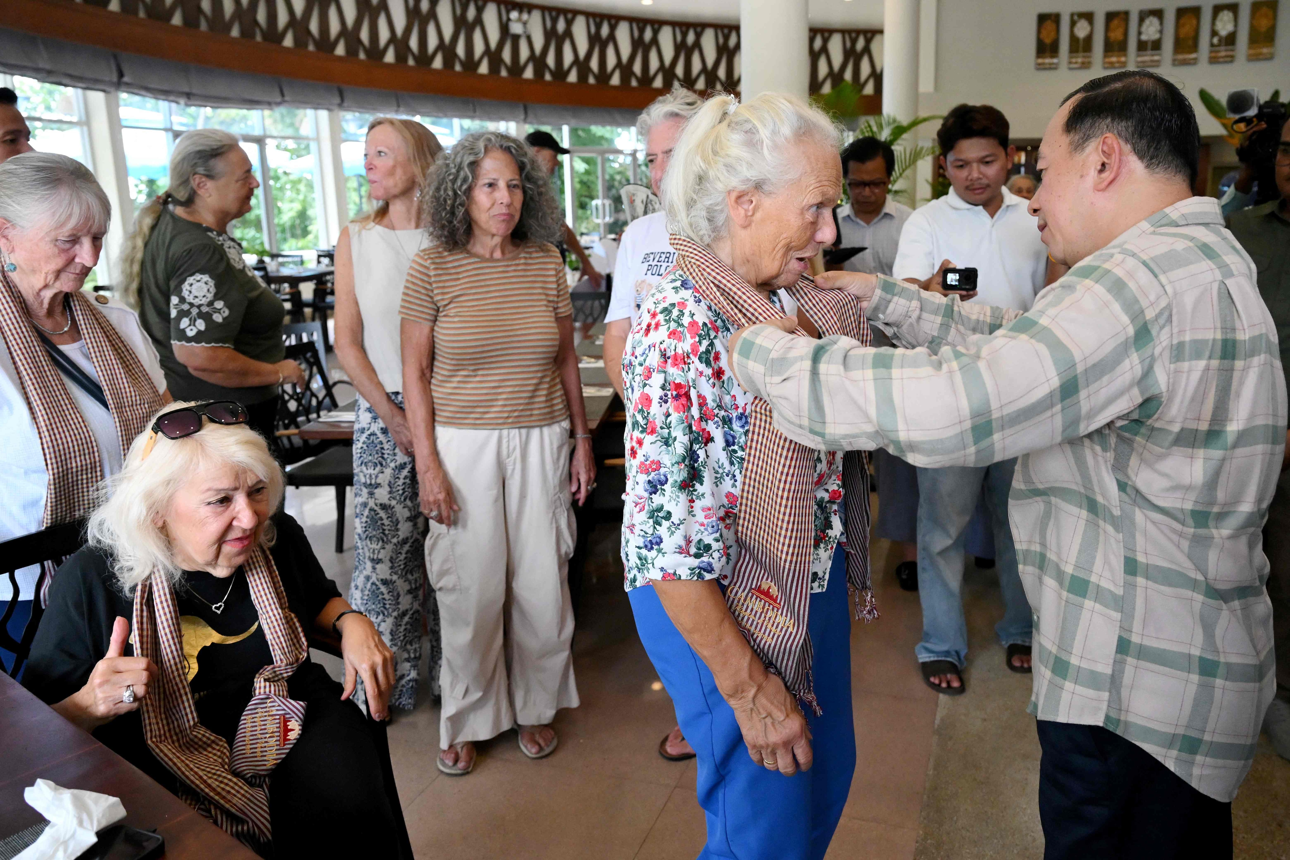Cambodia's Minister of Tourism Huot Hak (R) presents a scarf to a passenger of the Villa Vie Residences' cruise ship Odyssey at a hotel in Sihanoukville, Preah Sihanouk province on October 29, 2026. (AFP) Cambodia's Minister of Tourism Huot Hak (R) presents a scarf to a passenger of the Villa Vie Residences' cruise ship Odyssey at a hotel in Sihanoukville, Preah Sihanouk province on October 29, 2026. (AFP)