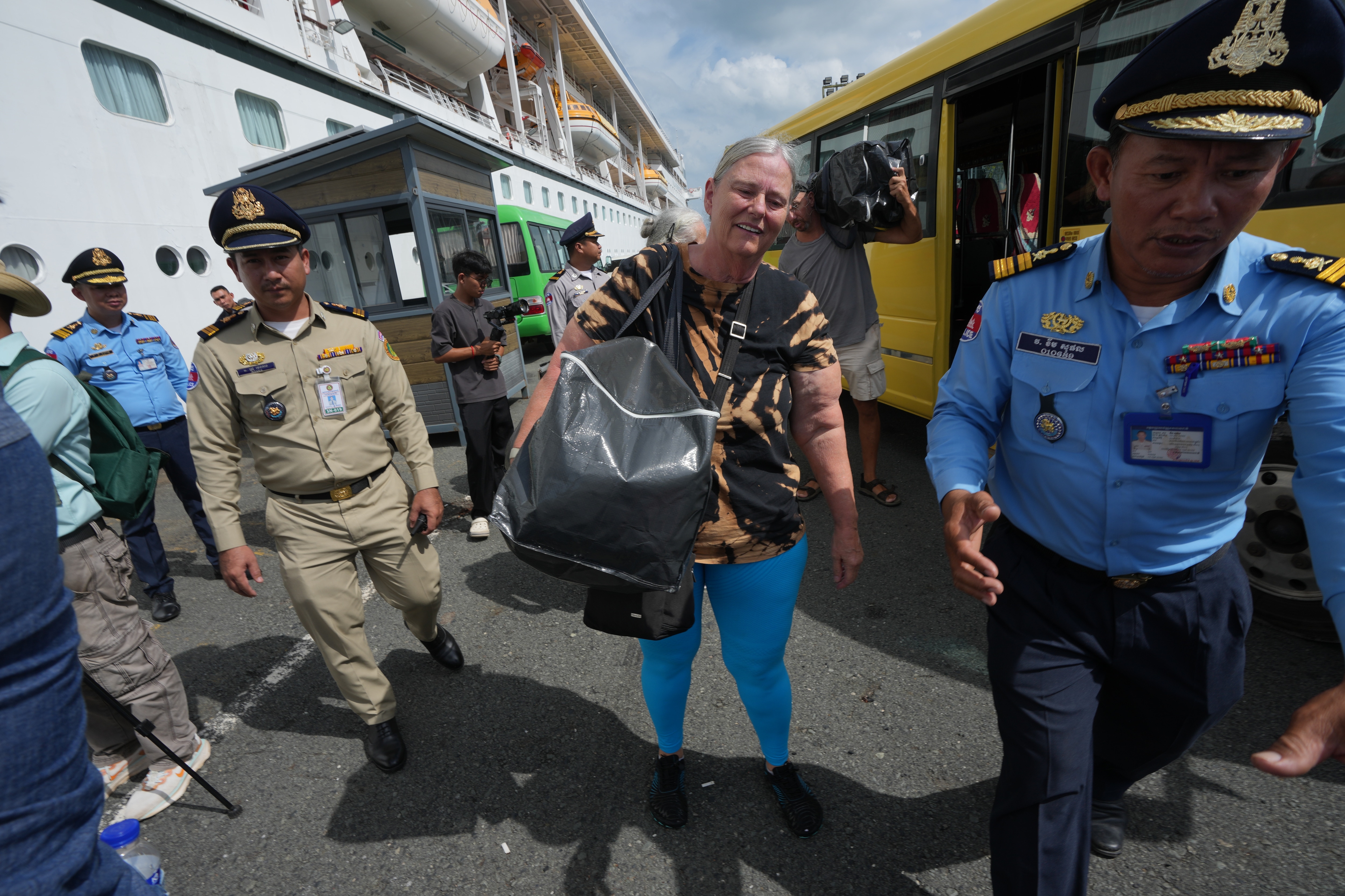 A passenger, center, from a U.S. cruise ship, the MV Odyssey, docked at the Sihanoukville Autonomous Port, returns aboard the ship in Sihanoukville, southern Cambodia, Thursday, Oct. 29, 2026. (AP Photo/Heng Sinith) (AP Photo/Heng Sinith) A passenger, center, from a U.S. cruise ship, the MV Odyssey, docked at the Sihanoukville Autonomous Port, returns aboard the ship in Sihanoukville, southern Cambodia, Thursday, Oct. 29, 2026. (AP Photo/Heng Sinith) (AP Photo/Heng Sinith)