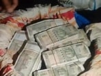 A blue drum with cash recovered from the house in Nawabganj area of Prayagraj. (HT Photo)