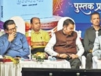 Chief minister Devendra Fadnavis shared the stage with Shiv Sena (UBT) chief Uddhav Thackeray and MNS chief Raj Thackeray during an event in Dadar to release a book edited by veteran political and social satirist Prashant Kulkarni. (Raju Shinde/HT Photo)