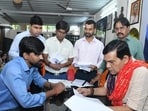 Energy minister AK Sharma during a public grievance hearing at his residence in Lucknow. (Sourced)