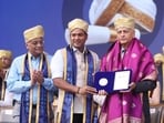 MIT-WPU executive president Rahul Karad (centre) felicitated former Chief Justice of India Justice Uday Lalit at the eight convocation ceremony of MIT World Peace University (MIT-WPU). (HT)