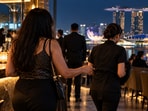 An Indian woman was fined after she touched a waitress inappropriately while partying at a Singapore bar.