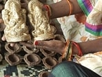 Rural women making lac and cow dung diyas and idols in Prayagraj (HT)