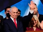 Israeli Prime Minister Benjamin Netanyahu, accompanied by his wife, Sara, waves to supporters at Likud party headquarters in Jerusalem.