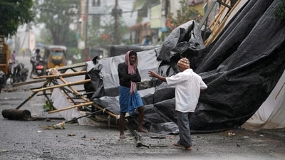 A man walks past the destruction caused at Kakinada, India, after Cyclone Arnab crossed the Andhra Pradesh coast. (AP) A man walks past the destruction caused at Kakinada, India, after Cyclone Arnab crossed the Andhra Pradesh coast. (AP)