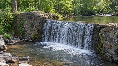 Pennsylvania removed the 7-foot Lochner Dam in 2006, but a downstream barrier continued to block migratory fish. The project was part of a broader national trend: 2,119 dams were removed from 1912 to 2023, including 390 in Pennsylvania. (AI-generated/ChatGPT)