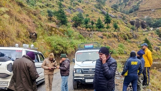 Chamoli: SDRF and other security personnel conduct a search and rescue operation at the site after a helicopter carrying six people on board crashed. (PTI)