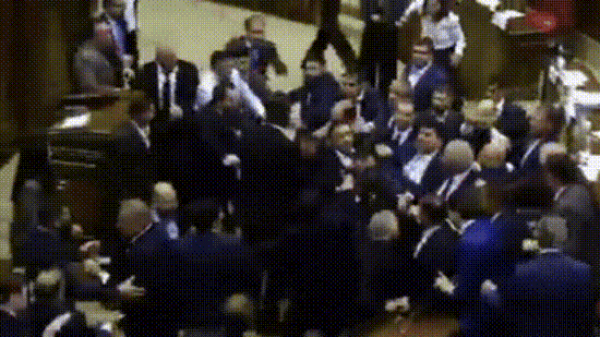 Several purported videos from inside Parliament surfaced on social media, showing lawmakers engaging in physical confrontations, exchanging punches and throwing chairs at one another. (X/@visegrad24)
