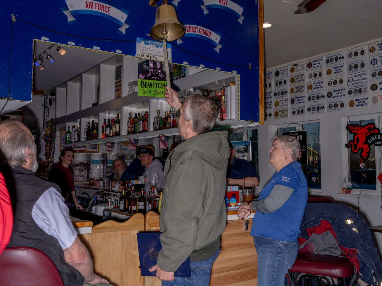 Sullivan rings the bell and tells the bar that he is paying for drinks at the American Legion post in Wasilla. Sullivan rings the bell and tells the bar that he is paying for drinks at the American Legion post in Wasilla.