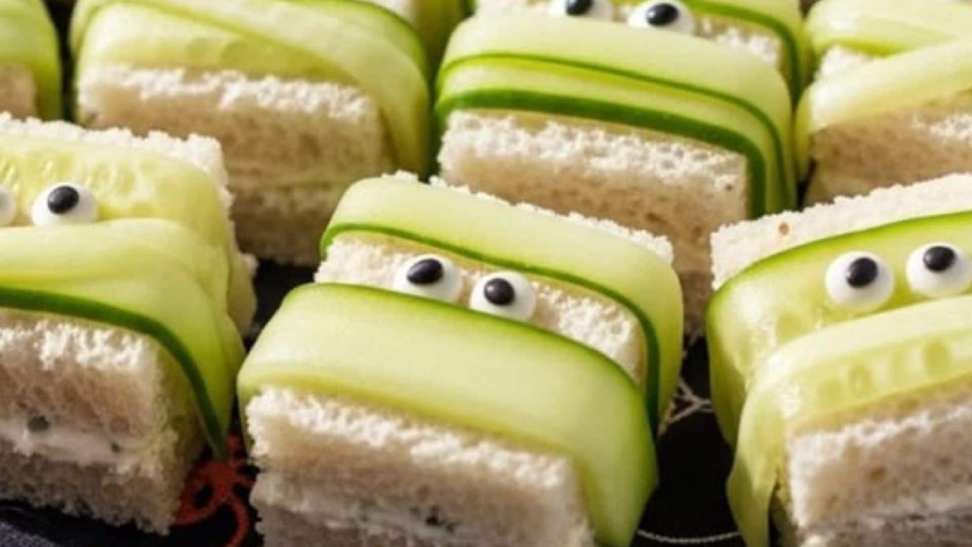 Cucumber ribbons and edible eyes transform simple sandwiches into playful monster faces. Cucumber ribbons and edible eyes transform simple sandwiches into playful monster faces.