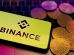 A smartphone with displayed Binance logo and representation of cryptocurrencies are placed on a keyboard in this illustration taken, June 8, 2023.