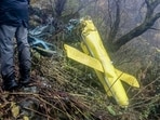 Wreckage of a private helicopter operated by Trans Bharat Aviation lying on a hillside near Chai village in the Joshimath area of Chamoli district, Uttarakhand.(PTI)