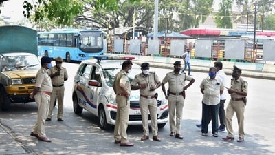 The Bengaluru police stand guard at BMTC bus stand, as coronavirus cases surge in Bengaluru, Wednesday (PTI)