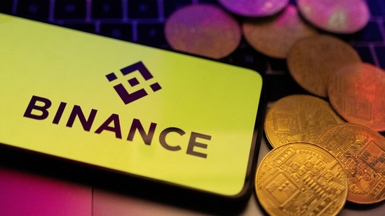 A smartphone with displayed Binance logo and representation of cryptocurrencies are placed on a keyboard in this illustration taken, June 8, 2023.