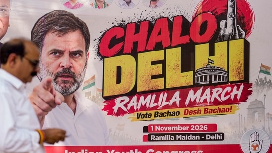 Anti-SIR protest LIVE updates: A man walks near a banner of Lok Sabha LoP Rahul Gandhi ahead of the "Chalo Delhi" Ramlila March, outside the Congress headquarters in New Delhi on Wednesday. Anti-SIR protest LIVE updates: A man walks near a banner of Lok Sabha LoP Rahul Gandhi ahead of the "Chalo Delhi" Ramlila March, outside the Congress headquarters in New Delhi on Wednesday.